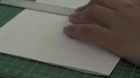 Creative hands crafting with precision at a workspace Stock Footage 323787335