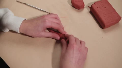 Creative Hands Shaping Red Clay: An Artistic Process Stock Footage 328476011