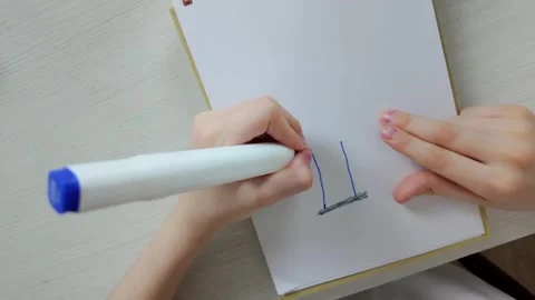 Creative Hands at Work Engaging in the Art of Drawing with a Colorful Marker Pen Stock Footage 301439111