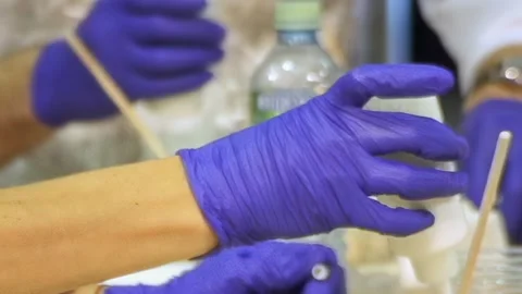 Creative Hands at Work With Purple Gloves During a Lively Crafting Session Stock Footage 340594261