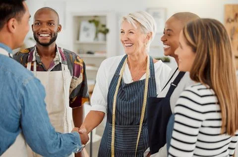 Creative, handshake and discussion with client, group and agreement in workshop Stock Photos
