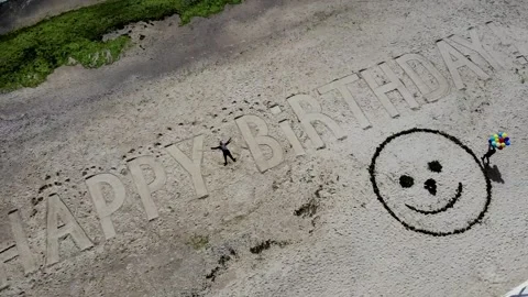 Creative happy birthday sign on the beach painted on sand Stock Footage 170390944