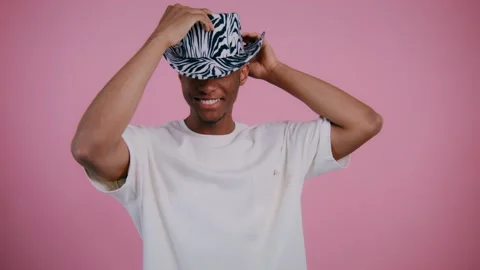 Creative headwear styling on a vibrant backdrop captivates viewers Stock Footage 307935686