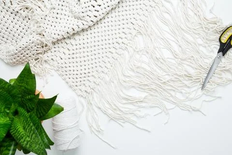 Creative hobby handmade macrame for home decoration. Weaving macrame at home. Stock Photos