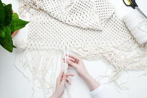 Creative hobby handmade macrame for home decoration. Girl weaves macrame. Wom Stock Photos