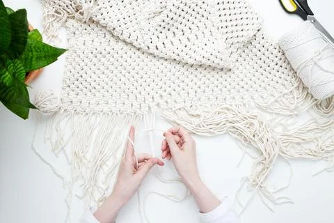 Creative hobby handmade macrame for home decoration. Girl weaves macrame. Wom Stock Photos