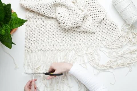 Creative hobby handmade macrame for home decoration. Girl weaves macrame. Wom Stock Photos