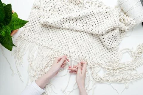 Creative hobby handmade macrame for home decoration. Girl weaves macrame. Wom Stock Photos