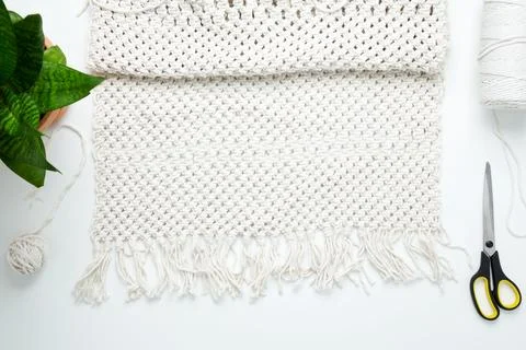 Creative hobby handmade macrame for home decoration. Weaving macrame at home. Stock Photos