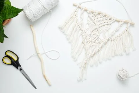 Creative hobby handmade macrame for home decoration. Weaving macrame at home. Stock Photos