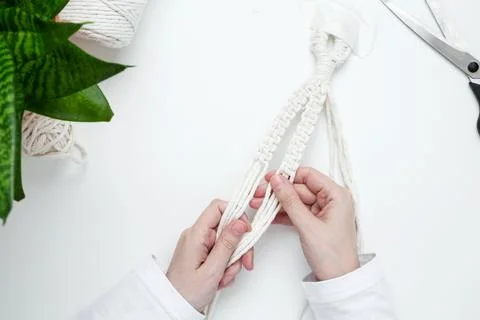 Creative hobby handmade macrame for home decoration. Girl weaves macrame. Wom Stock Photos