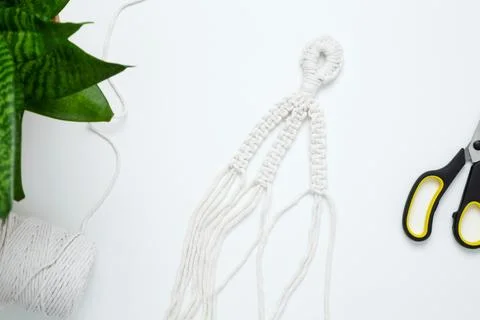 Creative hobby handmade macrame for home decoration. Weaving macrame at home. Stock Photos