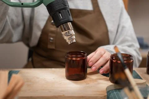 Creative hobby. Process of candle making. Close-up of Woman making candles fr Stock Photos