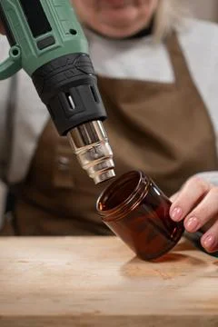 Creative hobby. Process of candle making. Close-up of Woman making candles fr Stock Photos
