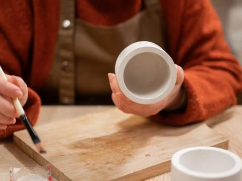 Creative hobby. Process of making gypsum candle holders. Close-up of woman ha Stock Photos