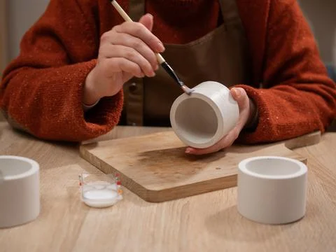 Creative hobby. Process of making gypsum candle holders. Close-up of woman ha Stock Photos