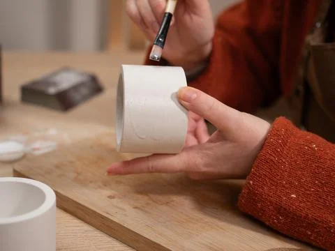 Creative hobby. Process of making gypsum candle holders. woman hands varnishi Stock Photos