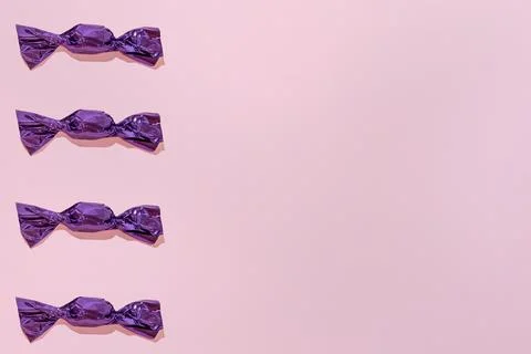 Creative Holiday Pattern violet Chocolates Pink Background copy space for tex Stock Photos