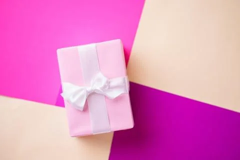 Creative holiday present on multicolored backdrop Stock Photos