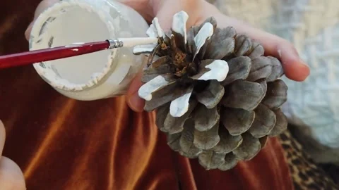 Creative home decor idea featuring a painted pine cone Stock-Footage 297527308