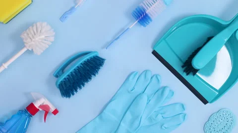 Creative household cleaning tools pattern on bright blue background. Stop motion Stock Footage 151426425