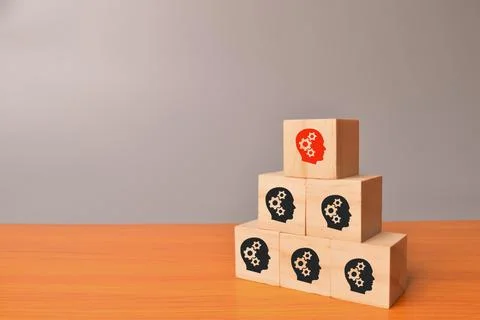 Creative idea and innovation concept. Wooden blocks with human head icons. Stock Photos