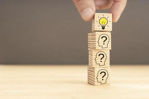 Creative idea and innovation concept. hand picking a wooden block with light Stock Photos