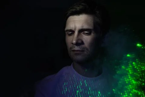 Creative idea, concept. young man and a projection of colored patterns on smoke. Stock Photos
