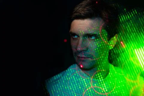 Creative idea, concept. young man and a projection of colored patterns on smoke. Stock Photos