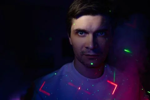 Creative idea, concept. young man and a projection of colored patterns on smoke. Stock Photos