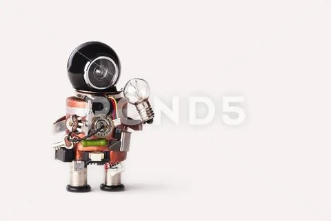 Creative idea inspiration concept. Robot handyman with lamp bulb. Creative Stock Photos