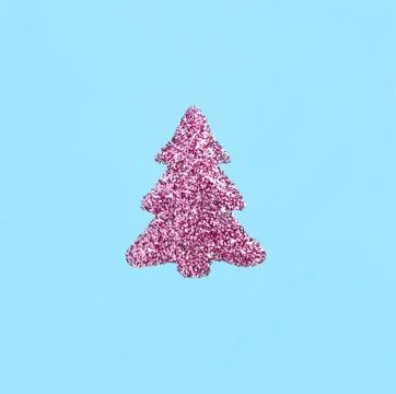 Creative image of a Christmas tree made of pink sequins on a blue background Stock Photos
