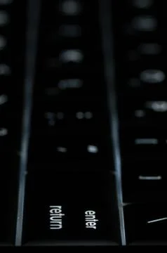 Creative image focusing on the enter return key with back light Stock Photos