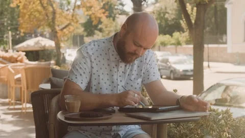 A Creative Individual Engaged in Work While Enjoying the Fresh Air at a Relaxing 스톡 동영상 282437911