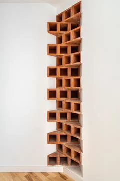 Creative interior corner of brown bricks in the apartment. Brickwork at white Stock Photos