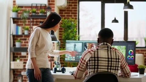 Creative interracial couple collaborating on video editing process Stock Footage 319718634