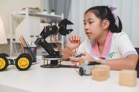 Creative kid assembling a DIY robot, representing future innovation. 写真素材