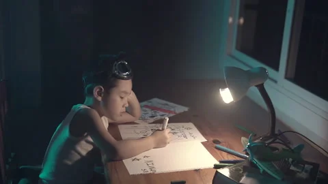 Creative kid drawing random designs on a sheet of paper on the kitchen Stock Footage 222882043