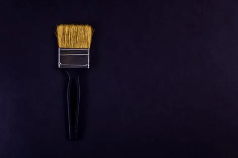 Creative layout black paint brush on black background Stock Photos