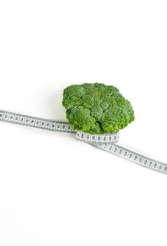 Creative layout broccoli with measuring tape concept diet, healthy lifestyle, Stock Photos