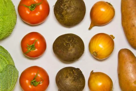 Creative layout of cabbage, onions, tomatoes, potatoes, carrots, beets. The c Stock Photos