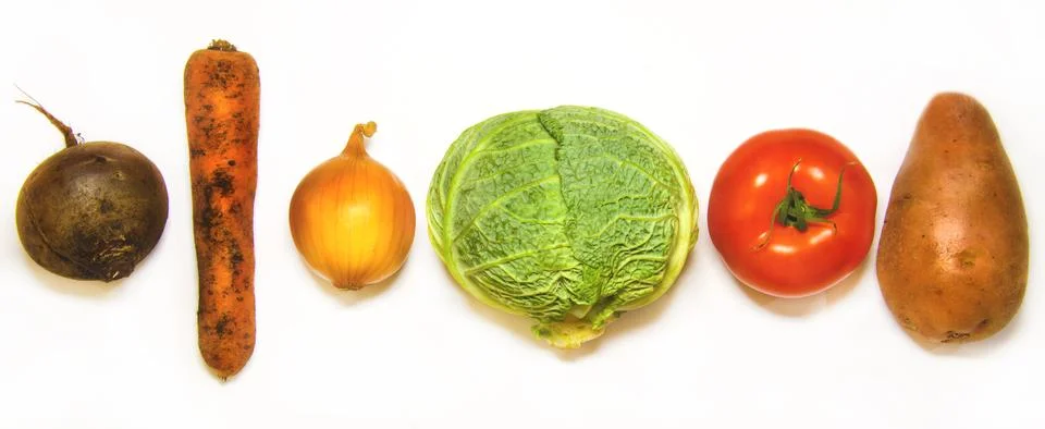 Creative layout of cabbage, onions, tomatoes, potatoes, carrots, beets. The c Stock Photos