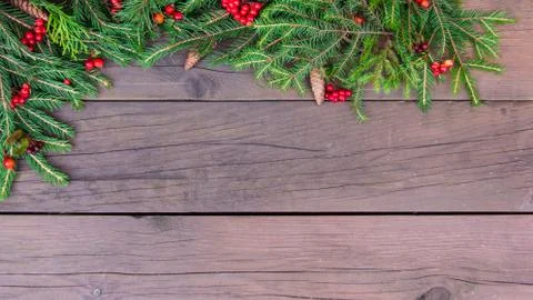 Creative layout of Christmas tree branches with cones, red berries and a pape Stock Photos