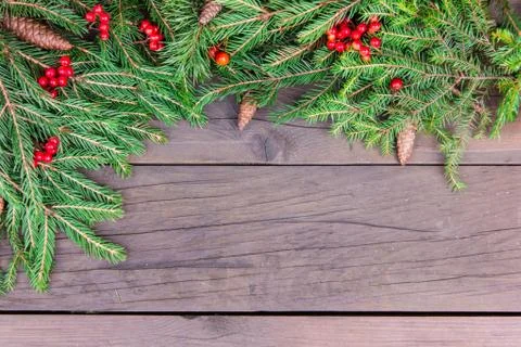 Creative layout of Christmas tree branches with cones, red berries and a pape Stock Photos