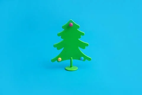 Creative layout with a Christmas tree on a bright blue background. Minimal wi Stock Photos
