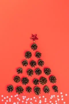 Creative layout of Christmas tree made of fir cones, star, with white snowfla Stock Photos