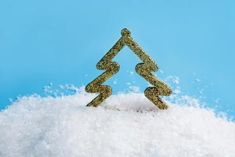 Creative layout with a Christmas tree in snow on a bright blue background. Mi Stock Photos