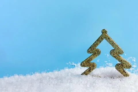 Creative layout with a Christmas tree in snow on a bright blue background. Mi Stock Photos