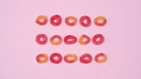 Creative layout concept with round gummy candies move. Stop motion flat lay Stock Footage 170323491