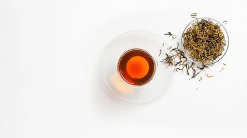 Creative layout of a cup of tea, red dried tea, on a white background. Stock Photos